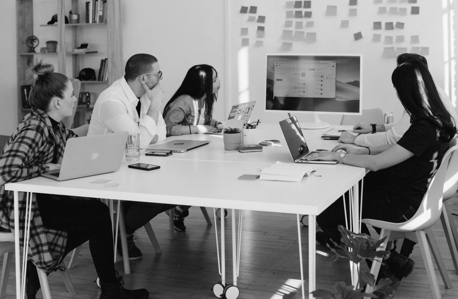 Professional testing coordination session with team members reviewing software functionality